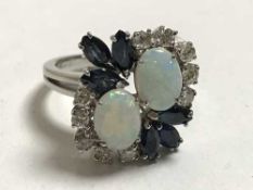 An 18ct white gold opal diamond and sapphire ring