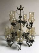 A brass and glass nine branch chandelier with glass drops