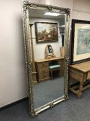 A large silvered bevelled overmantle mirror