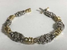 An 18ct yellow and white gold diamond set bracelet 18 grams, .