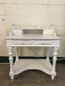 A contemporary white kneehole dressing table