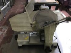 A stainless steel commercial meat slicer