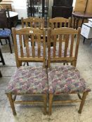 A set of four pine rail backed dining chairs