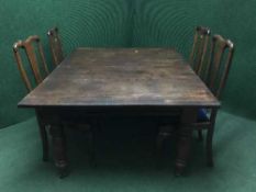 A Victorian mahogany wind out dining table with three leaves together with a set of four Queen Ann