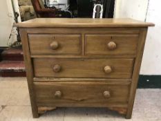 An early twentieth century pine four drawer chest