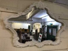 A contemporary white decorative overmantel mirror