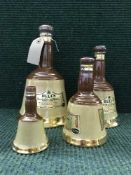A set of four graduated bells whisky decanters (sealed)