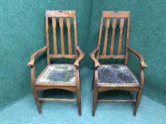 A pair of Edwardian oak high backed armchairs