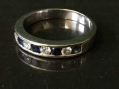 An 18ct white gold diamond and sapphire ring