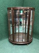 A walnut d-shaped display cabinet