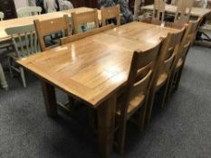 A solid oak extending dining table with two leaves and six chairs