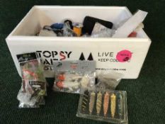 A box of fishing accessories including hooks, lures,