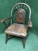 A Victorian oak armchair upholstered in buttoned leather