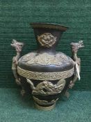 An Chinese bronze vase with gilt metal highlights depicting dragons