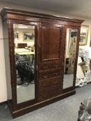 An Edwardian inlaid mahogany triple door wardrobe