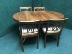 A Strongbow furniture inlaid yewwood dining table and four chairs