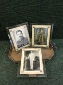 A twin handled serving tray together with four early twentieth century photograph frames and a