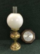 A brass Duplex oil lamp with glass shade and chimney together with an oak barometer