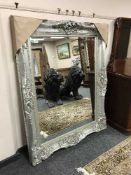 A bevelled silvered overmantel mirror