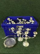 A basket containing a quantity of candleabra