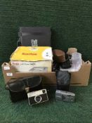 A box containing a quantity of cameras and camera equipment,