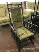 An American mahogany rocking chair upholstered in tapestry covering