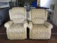 A pair of electric reclining armchairs upholstered in beige fabric