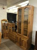 A pine glazed door display cabinet fitted with cupboards beneath together with accompanying chest