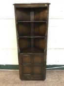 An Ercol corner cabinet