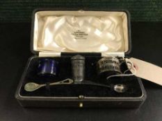 A cased silver miniature mustard pot with spoon, miniature salt pot,