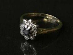 An 18ct gold sapphire and diamond cluster ring