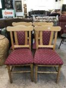 A set of four pine chairs upholstered in a burgandy fabric