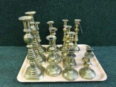 A tray of seven pairs of candlesticks