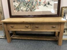 A pine farmhouse table fitted with two drawers