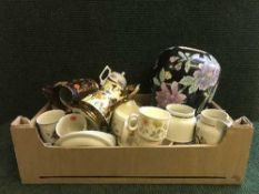 A box and basket of Royal Doulton Lambeth ware dinner service, copper lustre vases, tea cup planter,