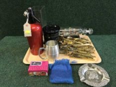 A tray of brass cutlery service, HMS victory ship in bottle, soda syphon,