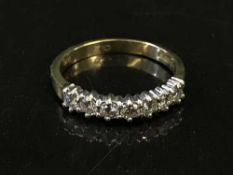 An 18ct gold seven stone diamond ring, approx 0.