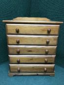 A pine four drawer chest