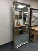 A large silvered bevelled overmantle mirror