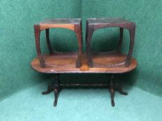 An oval mahogany coffee table together with matching lamp table