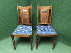 A pair of late Victorian oak dining chairs inset with leather panel