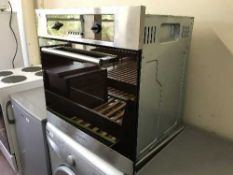 A stainless steel integrated wall oven