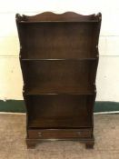 A set of mahogany open bookshelves fitted with a drawer