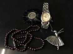 A jet memorial brooch, a silver ballerina brooch,