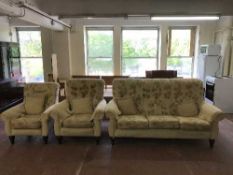 A three piece lounge suite upholstered in sand floral print