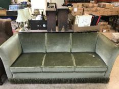 An early twentieth century three seater settee upholstered in green dralon fabric