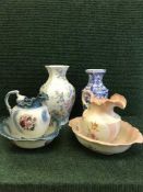 Two floral jug and basin sets together with a two floral patterned vases and lidded urn