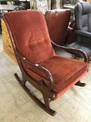 A mid twentieth cenutry Parker Knoll rocking chair upholstered in red fabric