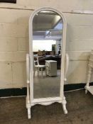 A contemporary white cheval mirror