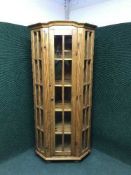 A pine glazed door corner display cabinet